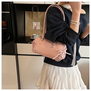Pink leather Boston shoulder bag with chic ribbon bows and elegant top handles