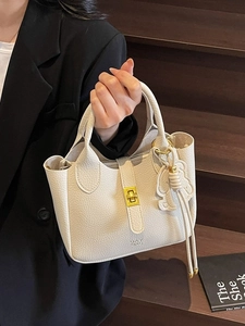 Minimalist beige pebble leather tote bag with gold lock and rabbit charm for women