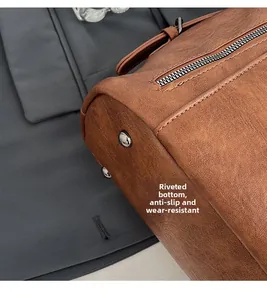 Detail view of the brown leather bag base featuring silver rivets and fine lychee texture