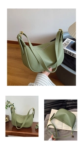 Detail of sage green lychee grain leather hobo bag with dual straps and metal buckles