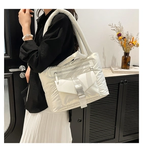 Dettaglio della borsa shopper trapuntata bianca con tasca con fibbia e finitura lucida chic
