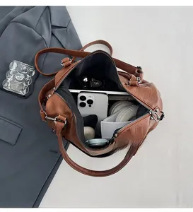 Interior view showing ample storage space for a tablet and headphones in the brown tote bag