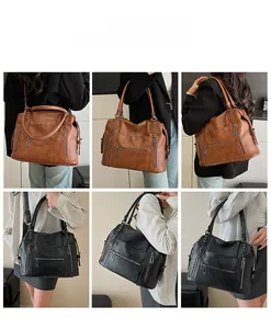 Detail view of large capacity faux leather tote bag with functional zippers and multi-pockets