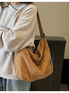 Brown large capacity canvas crossbody bag in Japanese style shown by model