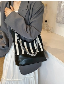 Chic black and white striped tote bag with silver metal chain and black leather trim