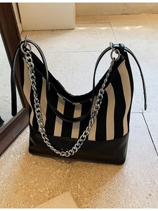 Vertical black and white striped tote bag with leather straps and silver chain detail