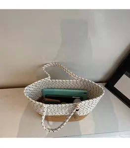 Top view of woven tote bag interior showing large capacity for tablet and phone