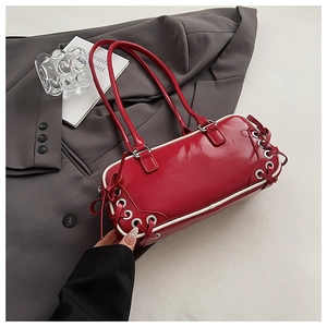 Detail of red patent leather bowling bag with white lacing and silver metal rivets