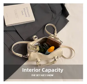 Internal capacity of cream pillow bag showing phone, perfume and lipstick inside