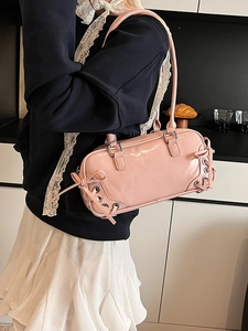 Pink patent leather baguette bag with silver lace-up details and metallic eyelets