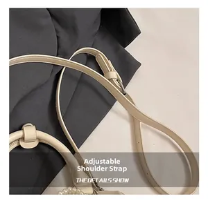 Close-up of adjustable cream leather shoulder strap with pearl handle details