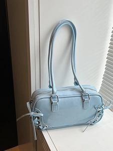 Fashionable light blue glossy bowling bag with silver rings and stylish bow details