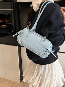 Light blue patent leather bowling bag with side bow detail and stylish shoulder strap
