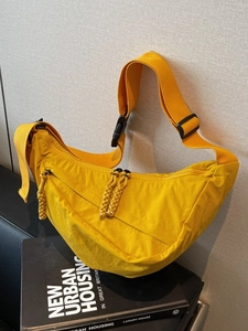 Large yellow nylon crescent shoulder bag with adjustable strap for casual daily commuting