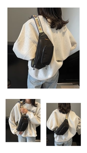 Detail of black nylon chest bag with colorful wide shoulder strap and dual zipper pockets
