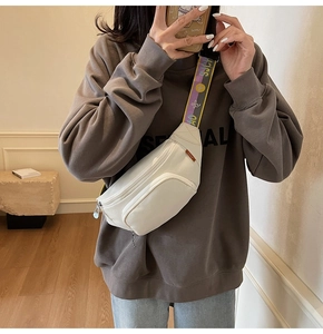 Detail of cream nylon crossbody bag with stylish wide floral printed shoulder strap