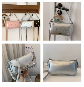 Detail view of stylish underarm bags featuring heart studs and a unique crackle texture finish