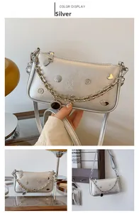 Silver chain underarm bag with metallic heart studs and adjustable shoulder strap
