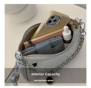 Silver crescent bag interior view showing storage capacity for phone and essentials