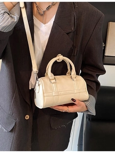 Chic beige cylinder pillow bag with smooth PU leather finish and detachable strap