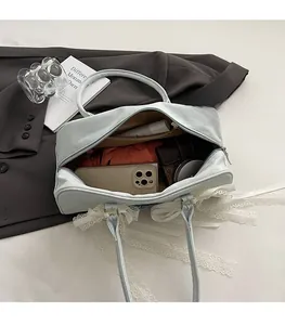 Detailansicht der hellblauen Jeans-Tasche mit geräumigem Innenraum, Spitze und Schleife