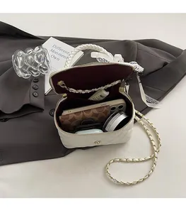Detail view of white quilted leather bag interior showing capacity for phone and wallet