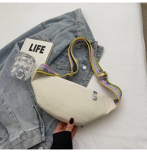 Detail of cream crescent chest bag with colorful patterned SJCHAO wide woven shoulder strap