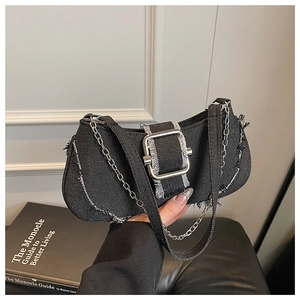 Detailed macro of black denim texture with vintage frayed edges and silver metal buckle