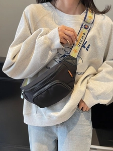 Black sporty chest bag with stylish jacquard embroidery strap shown on a female model