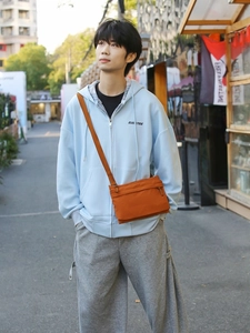 Orange nylon crossbody bag for women with adjustable strap and casual lightweight design