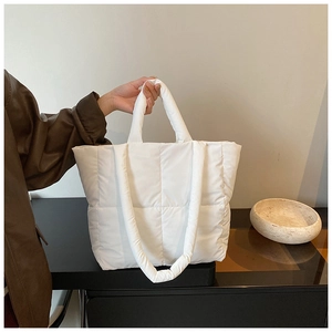 Détail du grand sac cabas matelassé blanc avec texture rembourrée et design épuré