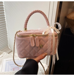 Pink quilted leather box bag with braided handle and chain strap detail
