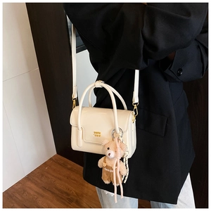 Chic cream white mini square bag with gold hardware and brown plush bear accessory
