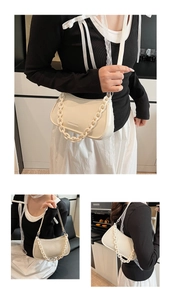 Detailed views of creamy white half-moon underarm bag with thick chain and leather strap