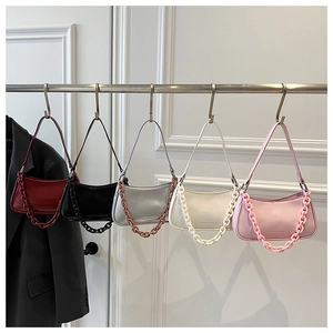 Detailed view of half-moon crossbody bags in multiple colors with acrylic chain decor