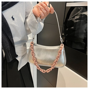 Detail of silver crescent bag with pink resin chain and Fashion & Bags text print