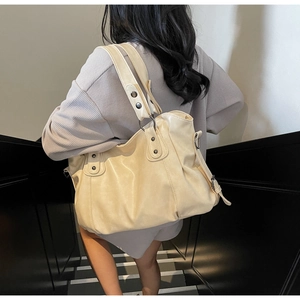 Detailed back view of a beige large-capacity tote bag with stylish pleated faux leather details