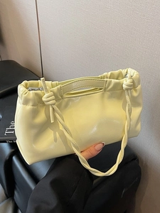 Minimalist cream yellow PU leather drawstring cloud handbag with a knotted shoulder strap