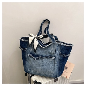 Détails des bords effilochés et du tissu en denim patchwork d'un grand sac fourre-tout rétro
