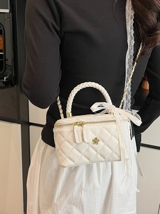 Elegant white quilted leather box bag with gold hardware and woven handle for women