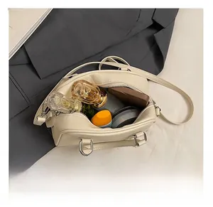 Internal capacity of off-white Boston crossbody bag showing daily essentials