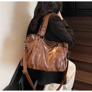Brown vintage large tote bag with silver metal rings and rivets for daily commute