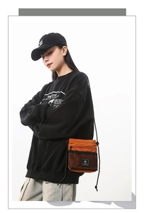 Crossbody bag in burnt orange with front mesh pocket styled on female model