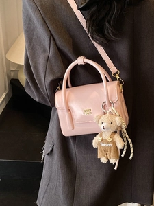 Pink patent leather crossbody square bag with gold logo and plush bear charm for women