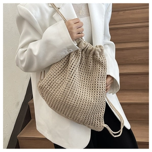 Close-up of beige crochet mesh drawstring bucket bag showing woven texture and hollow design