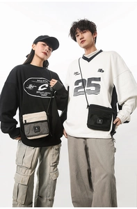 Outdoor lifestyle shot of beige and black functional crossbody bags with adjustable straps