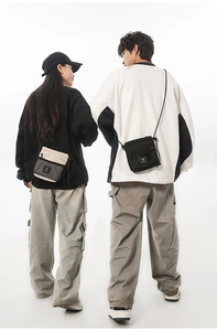 Street style display of functional cross-body bags in beige and black with mesh pocket