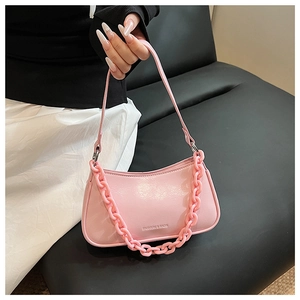 Detailed view of pink leather hobo bag with thick chain strap and Fashion & Bags embossing