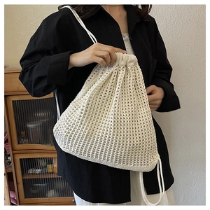 Detailed macro view of the cream crochet hollow-out drawstring backpack texture