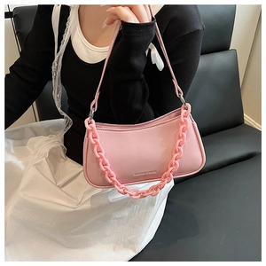Detail of pink baguette bag featuring thick resin chain and Fashion & Bags text logo